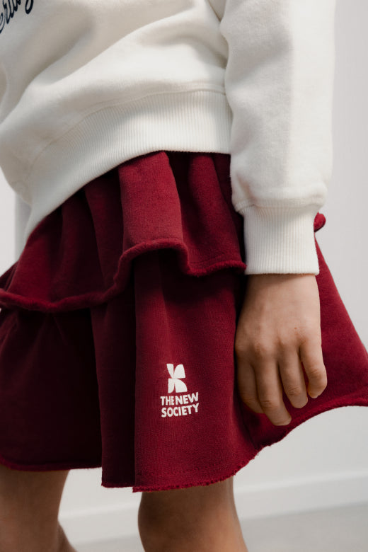 The New Society - TNS logo skirt - rumba red